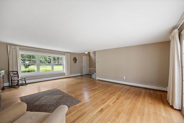 1519 Tuttle Ave, Wallingford, CT 06492 - living room featuring a baseboard heating unit, light wood-type flooring, and a baseboard radiator