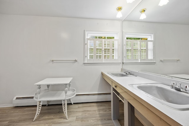 1519 Tuttle Ave, Wallingford, CT 06492 - bathroom with a baseboard heating unit, wood finished floors, and double vanity