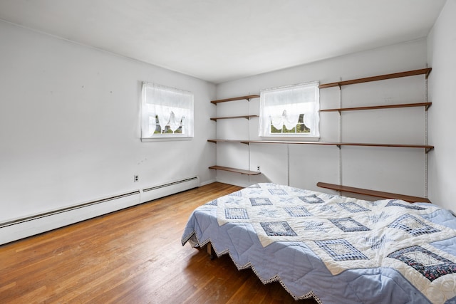 1519 Tuttle Ave, Wallingford, CT 06492 - bedroom with a baseboard heating unit and wood finished floors