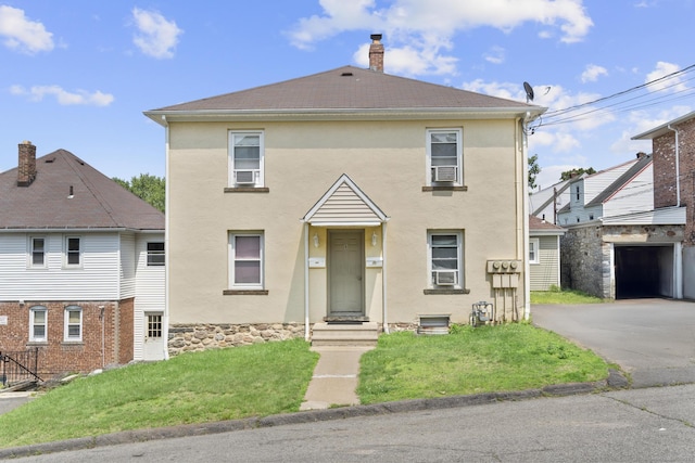 6 Houghton St, Bristol, CT 06010 - view of front facade with stucco siding, a front yard, driveway, and a chimney
