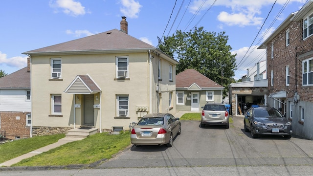 6 Houghton St, Bristol, CT 06010 - view of front of home with stucco siding, a chimney, and a front yard