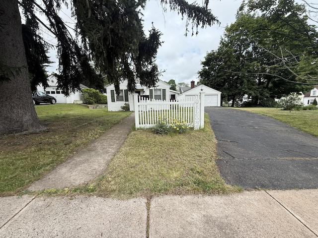 103 Starkweather St, Manchester, CT 06042 - view of front of property with an outdoor structure, a detached garage, and asphalt driveway
