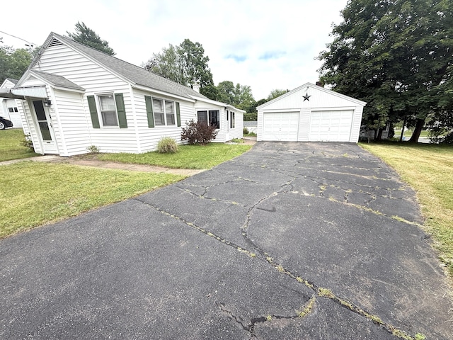 103 Starkweather St, Manchester, CT 06042 - ranch-style home with an outbuilding, a garage, a front yard, and roof with shingles