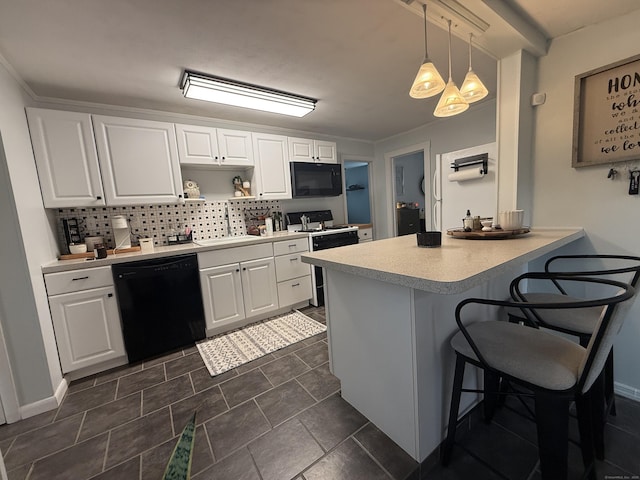 103 Starkweather St, Manchester, CT 06042 - kitchen with black appliances, a breakfast bar, a peninsula, and decorative backsplash