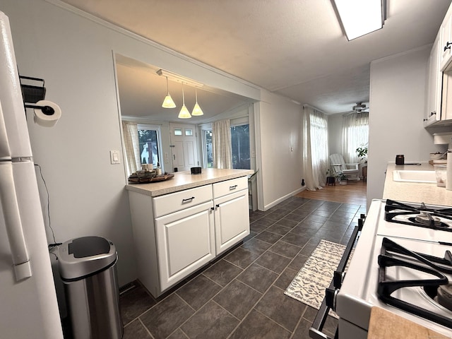 103 Starkweather St, Manchester, CT 06042 - kitchen featuring white range with gas stovetop, white cabinetry, light countertops, and hanging light fixtures