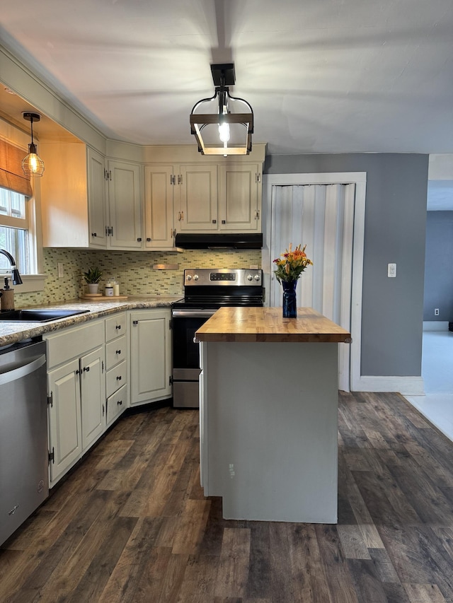 58 Barlow St, North Canaan, CT 06018 - kitchen with stainless steel appliances, under cabinet range hood, butcher block countertops, decorative backsplash, and pendant lighting