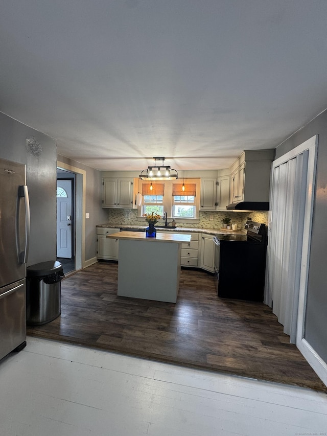 58 Barlow St, North Canaan, CT 06018 - kitchen with black / electric stove, freestanding refrigerator, tasteful backsplash, dark wood-style floors, and a center island