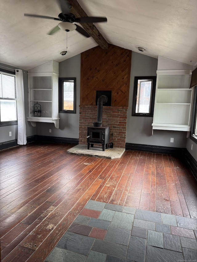 58 Barlow St, North Canaan, CT 06018 - unfurnished living room featuring wood-type flooring, a wood stove, a ceiling fan, and plenty of natural light