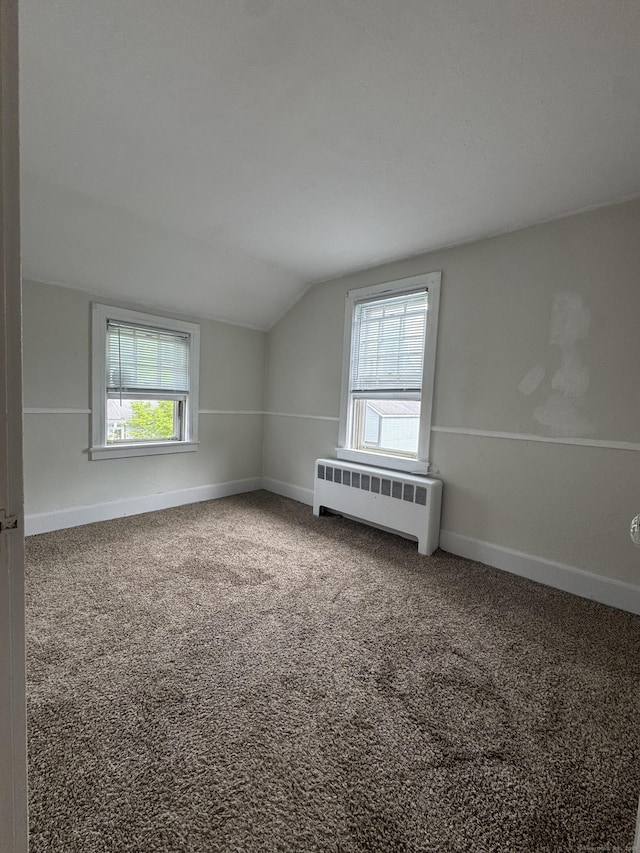 58 Barlow St, North Canaan, CT 06018 - carpeted empty room with radiator heating unit, plenty of natural light, and lofted ceiling
