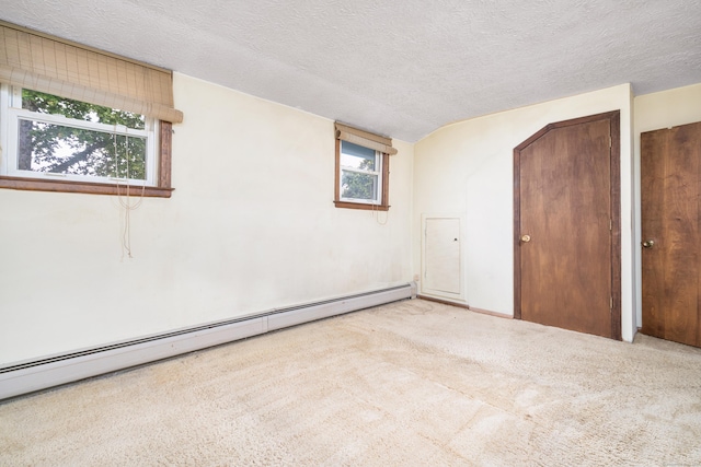 546 S Quaker Ln, West Hartford, CT 06110 - unfurnished bedroom with baseboard heating, carpet, and a textured ceiling