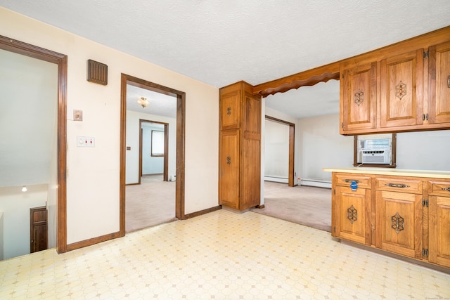 546 S Quaker Ln, West Hartford, CT 06110 - kitchen with brown cabinets, light countertops, cooling unit, baseboard heating, and a textured ceiling