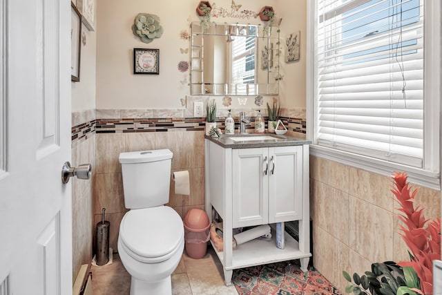 18 Morningside Ave, Waterbury, CT 06708 - half bathroom featuring tile walls, tile patterned floors, vanity, and a wainscoted wall