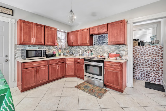 18 Morningside Ave, Waterbury, CT 06708 - kitchen featuring appliances with stainless steel finishes, light countertops, decorative backsplash, and light tile patterned flooring