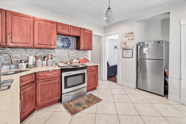 18 Morningside Ave, Waterbury, CT 06708 - kitchen with appliances with stainless steel finishes, decorative backsplash, light tile patterned floors, and hanging light fixtures