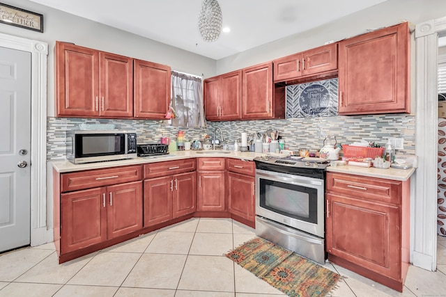 18 Morningside Ave, Waterbury, CT 06708 - kitchen featuring appliances with stainless steel finishes, light countertops, backsplash, light tile patterned floors, and recessed lighting