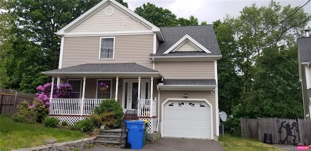 27 Amber Pl, Waterbury, CT 06705 - view of front of property featuring covered porch, an attached garage, roof with shingles, and asphalt driveway