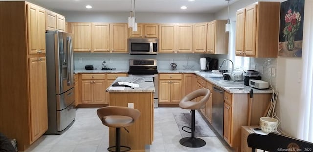 27 Amber Pl, Waterbury, CT 06705 - kitchen with stainless steel appliances, a kitchen island, backsplash, light brown cabinets, and light stone counters