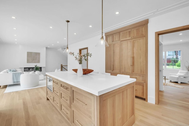 133 E Ave Unit A, New Canaan, CT 06840 - kitchen with light wood-style floors, recessed lighting, open floor plan, a center island, and light brown cabinets