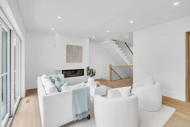 133 E Ave Unit A, New Canaan, CT 06840 - living area with light wood finished floors, recessed lighting, and a glass covered fireplace