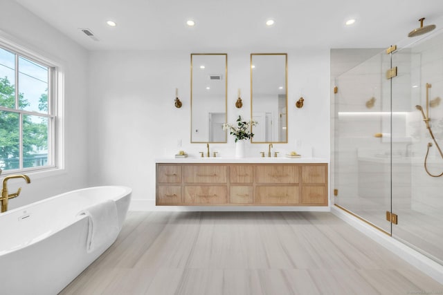 133 E Ave Unit A, New Canaan, CT 06840 - bathroom featuring a stall shower, double vanity, a freestanding tub, and recessed lighting