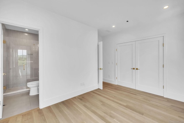 133 E Ave Unit A, New Canaan, CT 06840 - unfurnished bedroom with light wood-style flooring, recessed lighting, connected bathroom, and a closet
