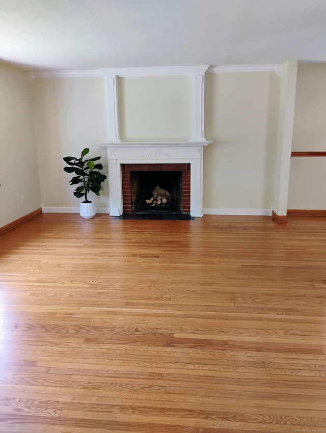 3 Rye Ridge Parkway, West Hartford, CT 06117 - unfurnished living room featuring light wood-style floors, a brick fireplace, and crown molding