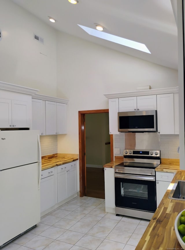 3 Rye Ridge Parkway, West Hartford, CT 06117 - kitchen with appliances with stainless steel finishes, wooden counters, a skylight, white cabinets, and backsplash