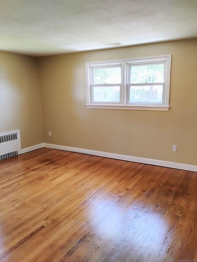 3 Rye Ridge Parkway, West Hartford, CT 06117 - unfurnished room with plenty of natural light, radiator heating unit, and wood finished floors