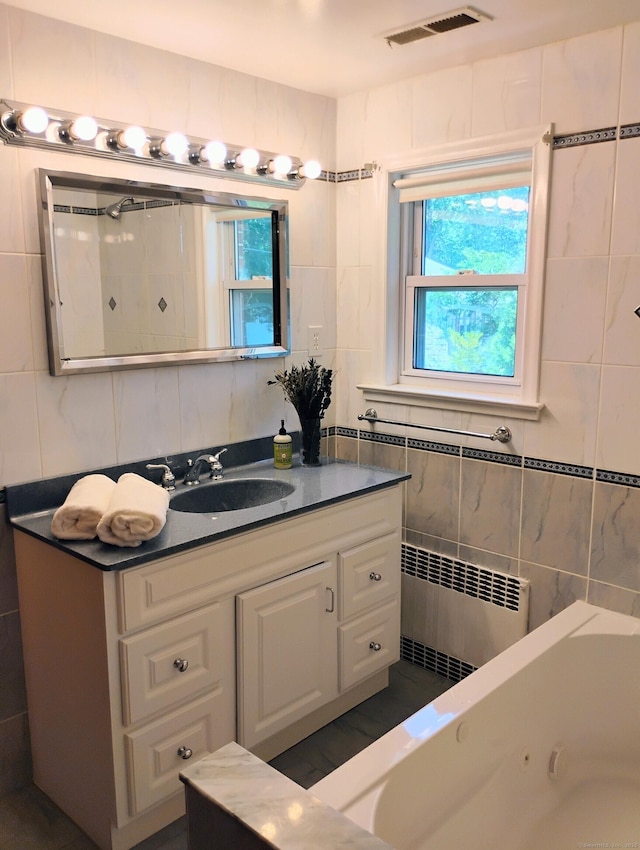 3 Rye Ridge Parkway, West Hartford, CT 06117 - full bath with radiator, tile walls, a jetted tub, and vanity