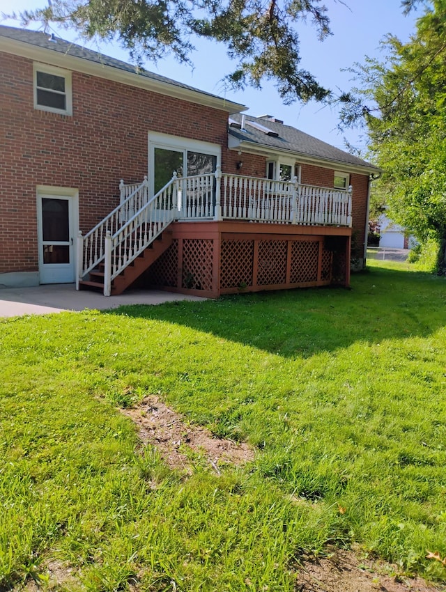 3 Rye Ridge Parkway, West Hartford, CT 06117 - back of property featuring a wooden deck, brick siding, a lawn, and stairs