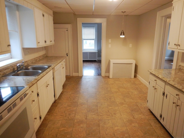 11 Morton St, New London, CT 06320 - kitchen featuring radiator, a paneled ceiling, white appliances, decorative light fixtures, and white cabinets