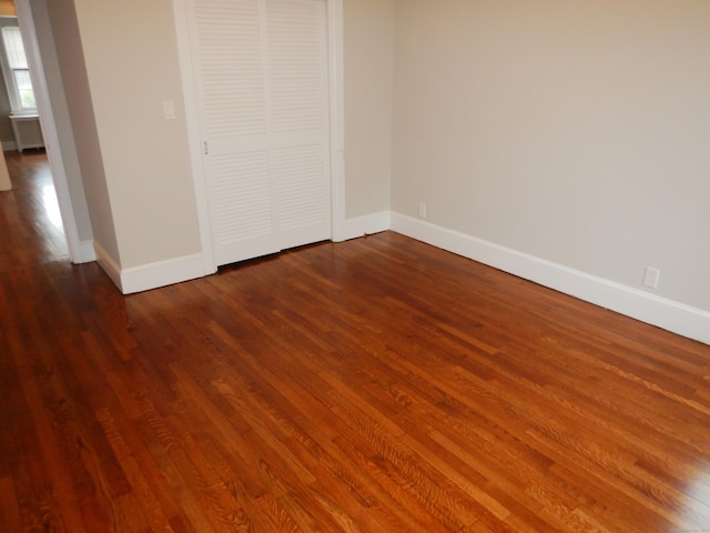 11 Morton St, New London, CT 06320 - unfurnished bedroom with dark wood-style flooring and a closet