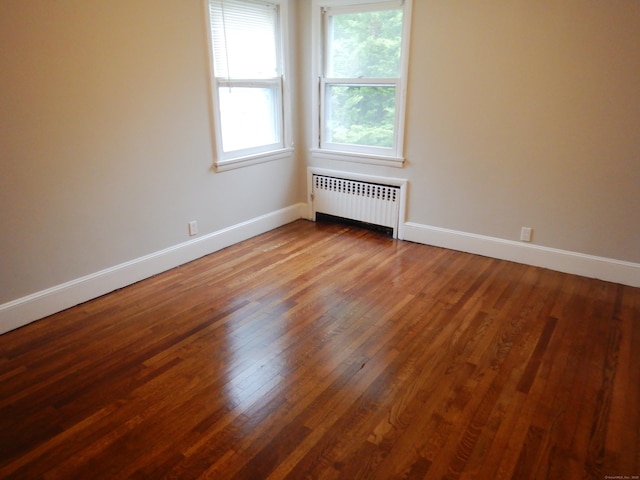 11 Morton St, New London, CT 06320 - empty room featuring radiator and wood finished floors