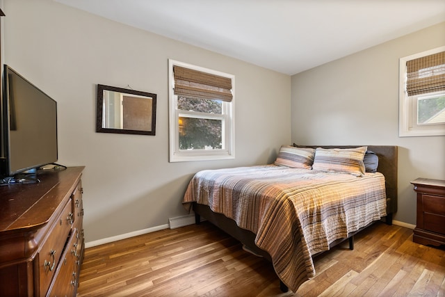 301 Pondview Dr, Southington, CT 06489 - bedroom with light wood-style flooring and baseboard heating
