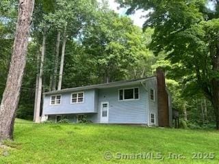 166 River Rd, East Haddam, CT 06423 - back of property with a chimney and a yard