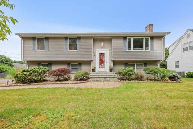 142 Raffia Rd, Enfield, CT 06082 - split foyer home with a chimney and a front lawn