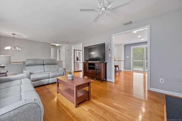 142 Raffia Rd, Enfield, CT 06082 - living room with a chandelier, a ceiling fan, and light wood-type flooring