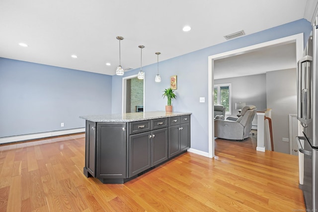 142 Raffia Rd, Enfield, CT 06082 - kitchen featuring a baseboard heating unit, high quality fridge, light wood finished floors, a peninsula, and light stone countertops