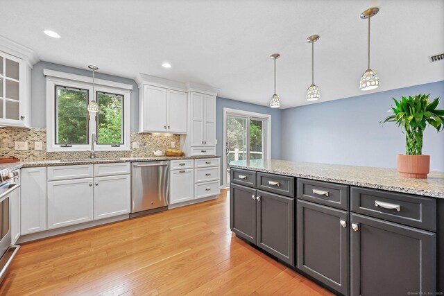 142 Raffia Rd, Enfield, CT 06082 - kitchen featuring appliances with stainless steel finishes, light wood-style flooring, white cabinets, backsplash, and recessed lighting