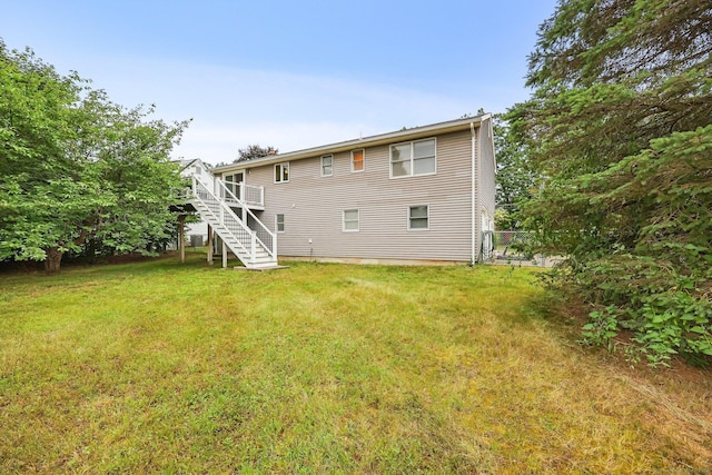 142 Raffia Rd, Enfield, CT 06082 - back of property featuring stairway and a yard