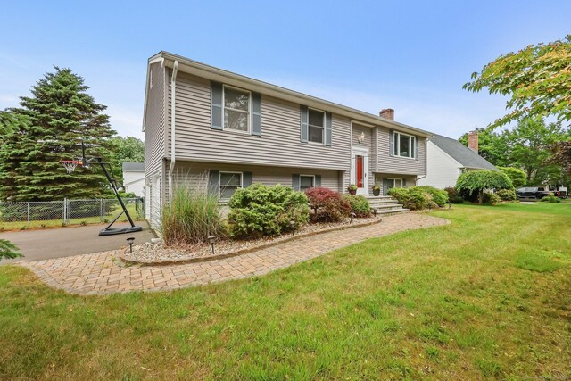 142 Raffia Rd, Enfield, CT 06082 - split foyer home featuring a chimney