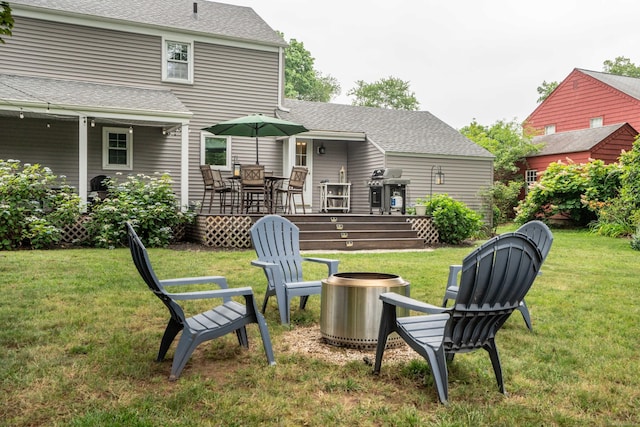 11 Craigmoor Rd, West Hartford, CT 06107 - view of grassy yard with a deck, an outdoor fire pit, and outdoor dining space