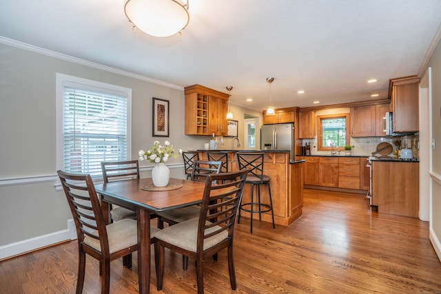 11 Craigmoor Rd, West Hartford, CT 06107 - dining space with light wood-style flooring, crown molding, and recessed lighting