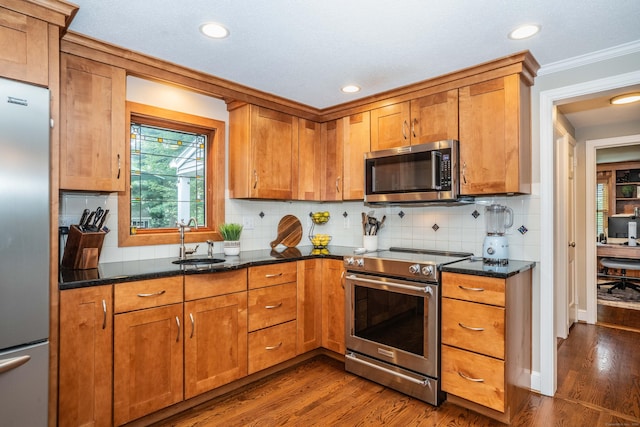 11 Craigmoor Rd, West Hartford, CT 06107 - kitchen with stainless steel appliances, dark wood-style flooring, brown cabinets, recessed lighting, and ornamental molding