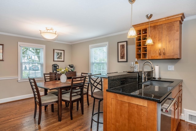 11 Craigmoor Rd, West Hartford, CT 06107 - kitchen with brown cabinetry, plenty of natural light, dark wood-style flooring, ornamental molding, and a kitchen breakfast bar