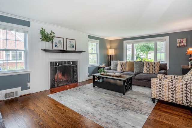 11 Craigmoor Rd, West Hartford, CT 06107 - living area with wood finished floors, crown molding, and a fireplace with flush hearth