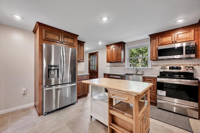112 Shadow Ln, West Hartford, CT 06110 - kitchen featuring appliances with stainless steel finishes, light countertops, decorative backsplash, recessed lighting, and light tile patterned floors