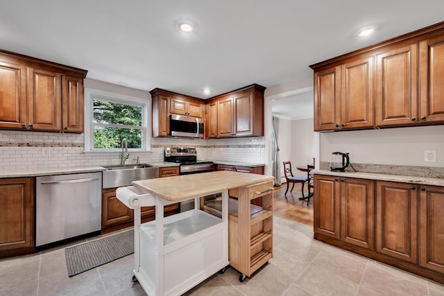 112 Shadow Ln, West Hartford, CT 06110 - kitchen with appliances with stainless steel finishes, decorative backsplash, recessed lighting, brown cabinetry, and light stone countertops