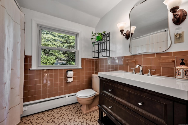 112 Shadow Ln, West Hartford, CT 06110 - bathroom featuring a baseboard heating unit, vanity, tile walls, wainscoting, and vaulted ceiling