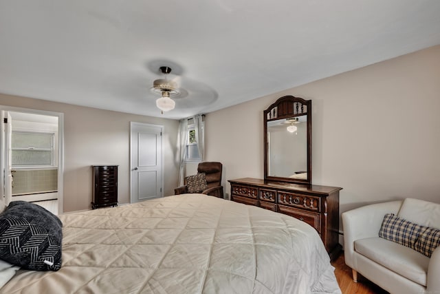 112 Shadow Ln, West Hartford, CT 06110 - bedroom featuring a baseboard heating unit, a ceiling fan, and wood finished floors